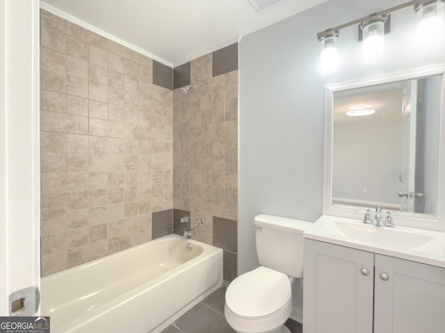 full bathroom with tile patterned floors, toilet, vanity, and tiled shower / bath