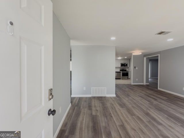 unfurnished living room featuring hardwood / wood-style flooring