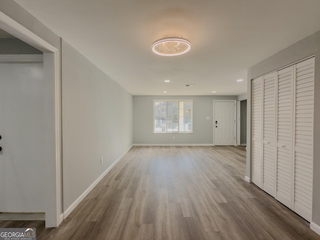 unfurnished living room featuring wood-type flooring