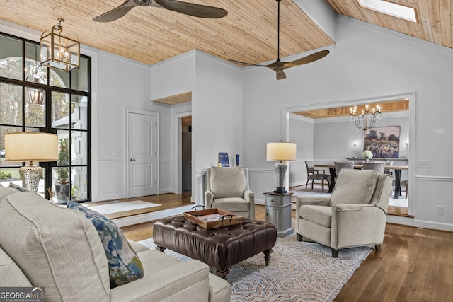 living room featuring hardwood / wood-style floors, wood ceiling, a high ceiling, and a skylight