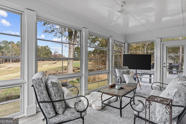 sunroom / solarium featuring ceiling fan