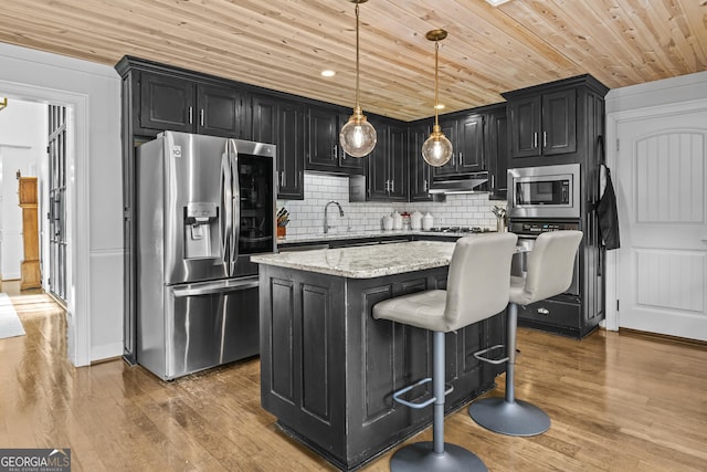 kitchen with appliances with stainless steel finishes, light stone counters, wood ceiling, a center island, and hanging light fixtures