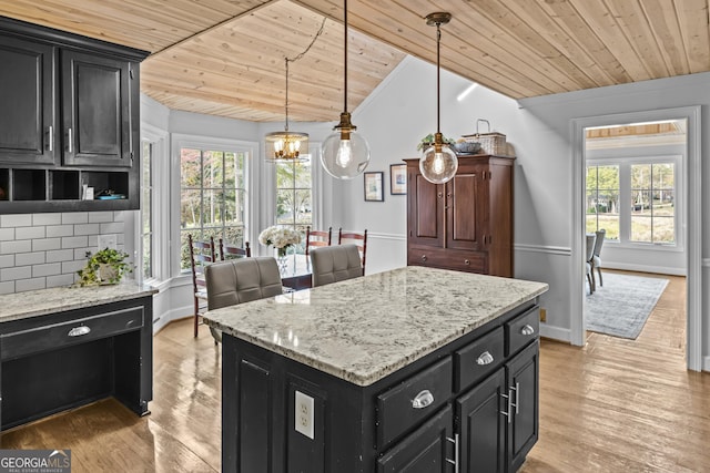 kitchen featuring backsplash, decorative light fixtures, wooden ceiling, light hardwood / wood-style floors, and a kitchen island