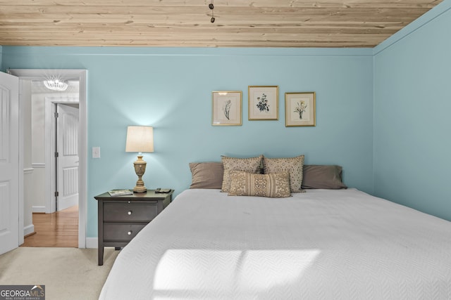 bedroom with light colored carpet and wooden ceiling