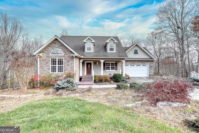 new england style home featuring covered porch, a front lawn, and a garage