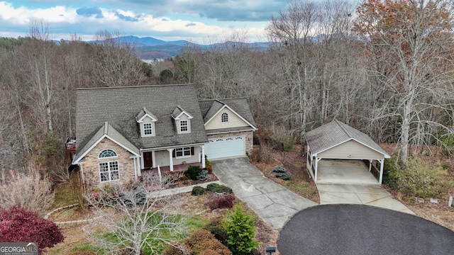 new england style home featuring a garage, a carport, and a mountain view