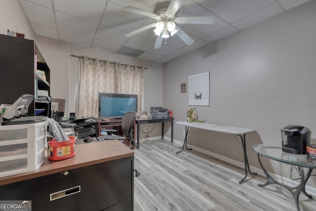 office area featuring a drop ceiling, ceiling fan, and light hardwood / wood-style flooring