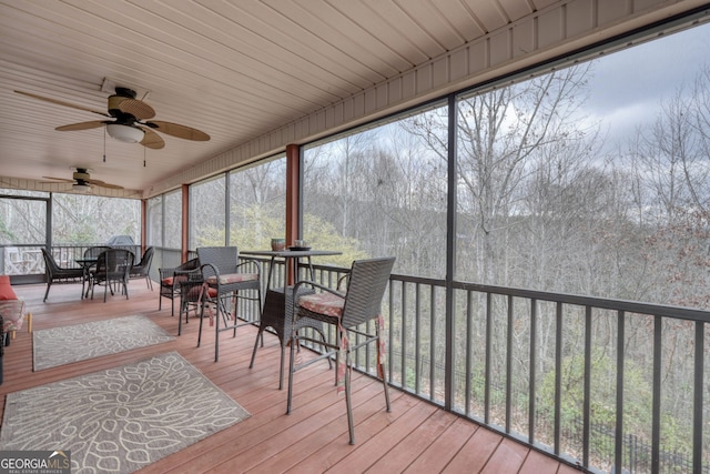 sunroom / solarium featuring ceiling fan