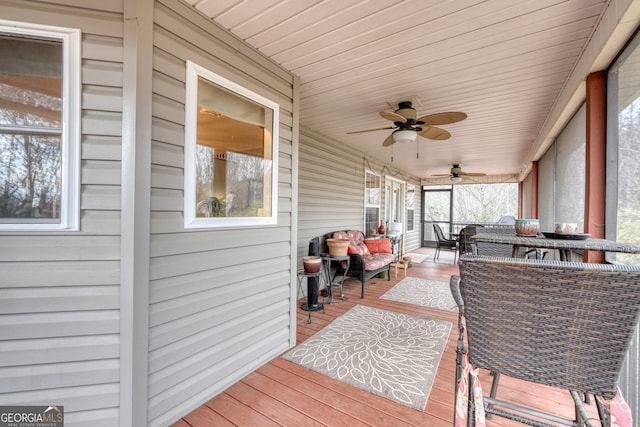 deck featuring ceiling fan and outdoor lounge area