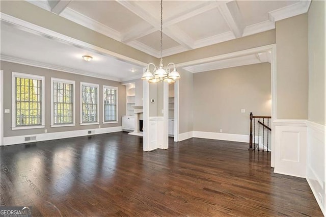 unfurnished living room with dark hardwood / wood-style flooring, ornamental molding, coffered ceiling, a notable chandelier, and beamed ceiling