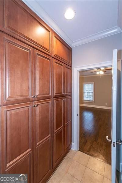 interior space with crown molding, hardwood / wood-style floors, and ceiling fan