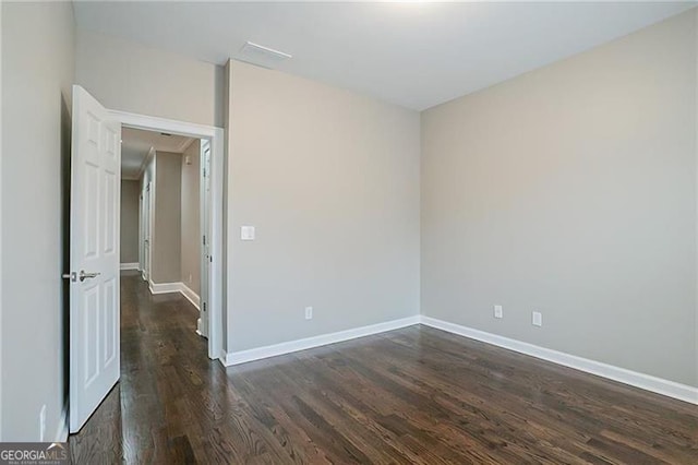 spare room with dark hardwood / wood-style flooring