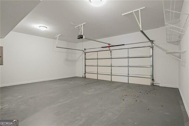 garage featuring electric panel and a garage door opener