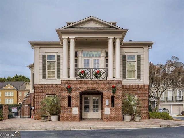 neoclassical home with a balcony