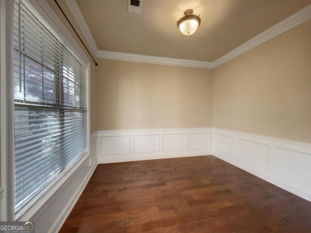 spare room with dark hardwood / wood-style floors and crown molding