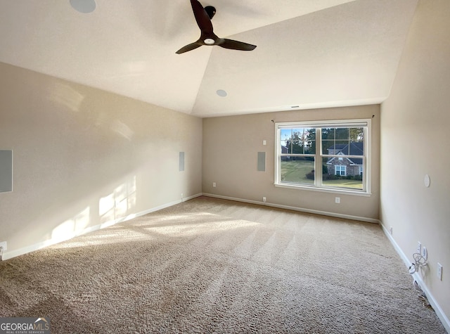 spare room featuring ceiling fan, lofted ceiling, and light carpet