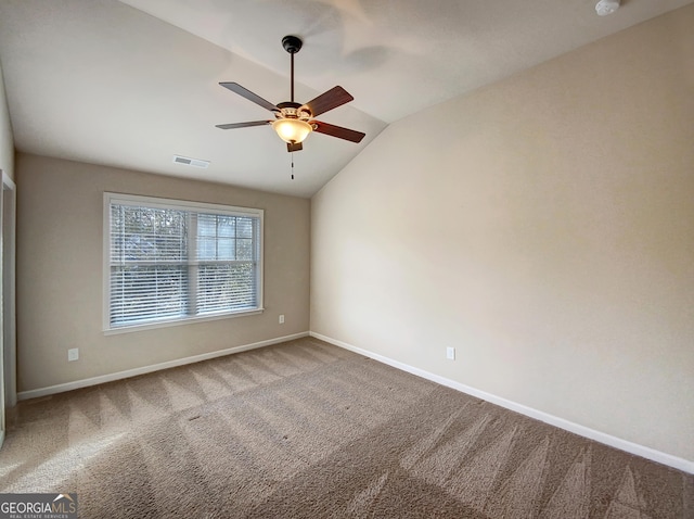 unfurnished room with carpet flooring, vaulted ceiling, and ceiling fan