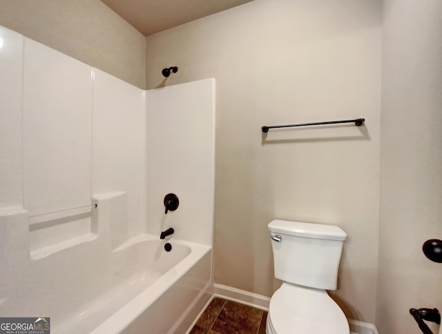 bathroom featuring tile patterned flooring, tub / shower combination, and toilet