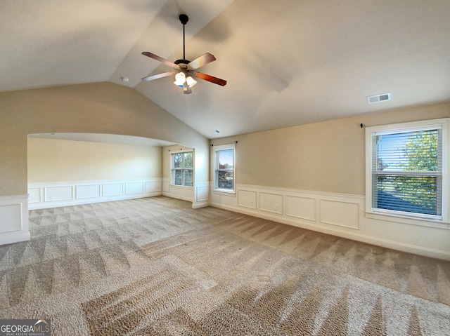 interior space featuring carpet, ceiling fan, and lofted ceiling