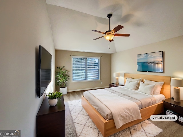 bedroom featuring light wood-type flooring, ceiling fan, and lofted ceiling