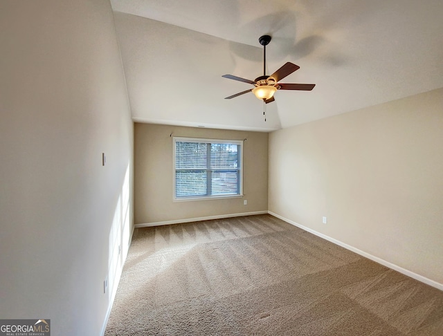 carpeted empty room with ceiling fan and lofted ceiling