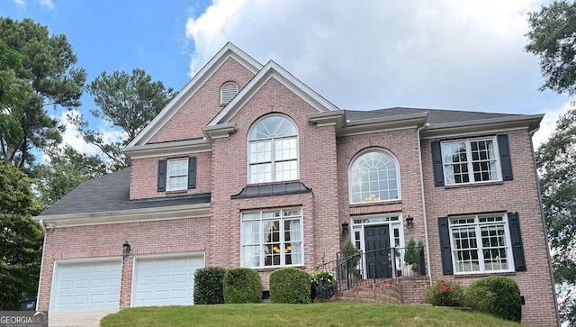 view of front of property featuring a garage and a front yard