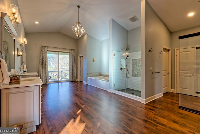 bathroom with vanity, lofted ceiling, hardwood / wood-style flooring, shower with separate bathtub, and a chandelier