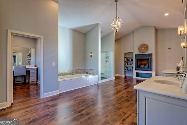 bathroom featuring shower with separate bathtub, vanity, lofted ceiling, and wood-type flooring