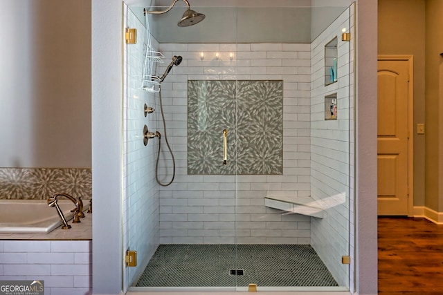 bathroom featuring separate shower and tub