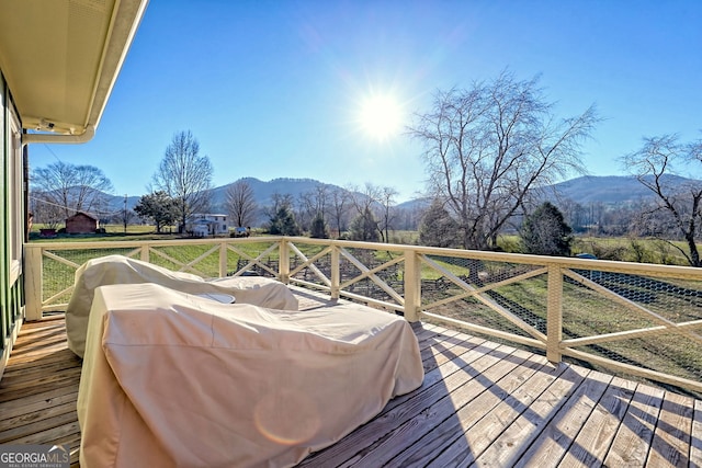 wooden terrace with a mountain view and grilling area