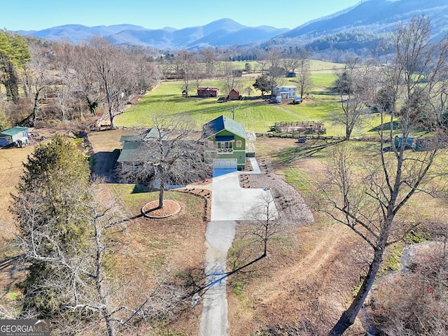 drone / aerial view featuring a mountain view and a rural view