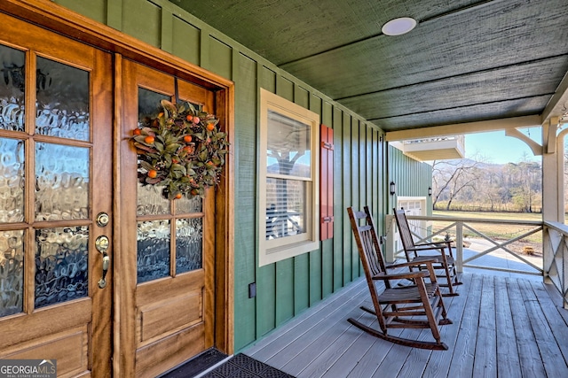 wooden terrace with a porch