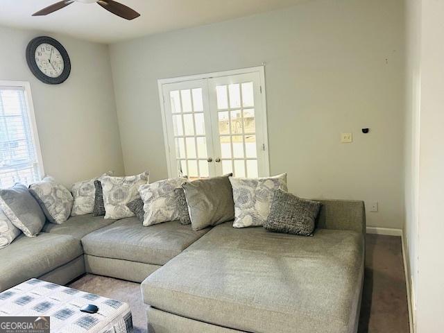 carpeted living room featuring ceiling fan and french doors