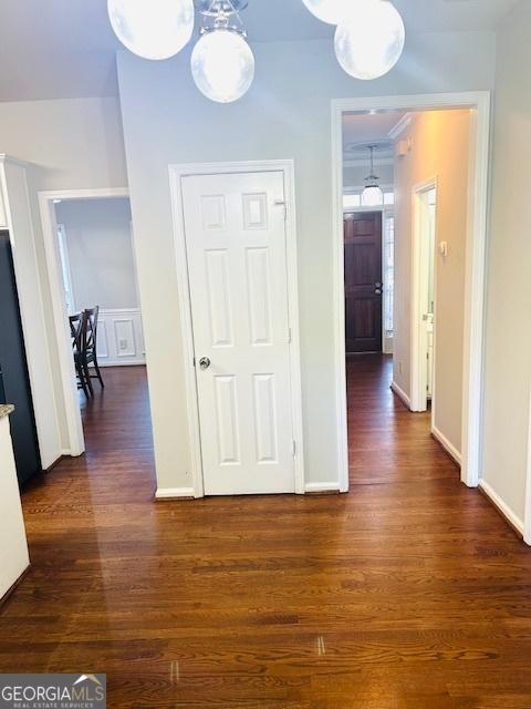 hallway with dark wood-type flooring