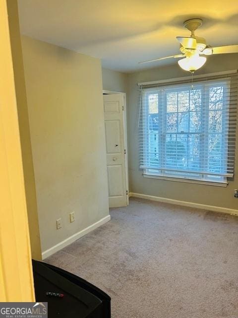 carpeted empty room with ceiling fan