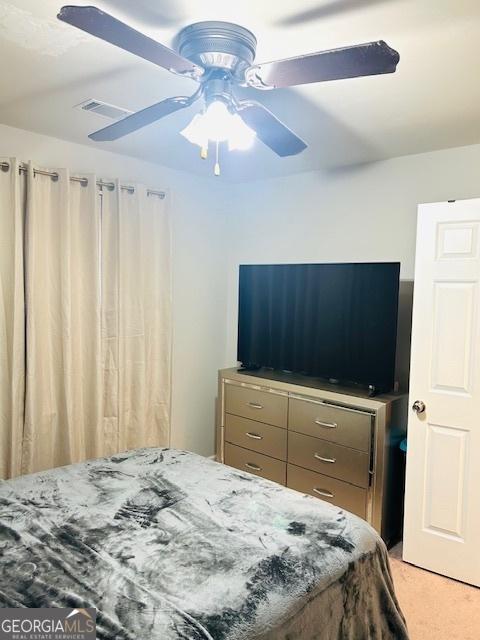 carpeted bedroom with ceiling fan