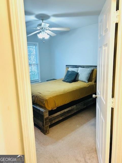 bedroom with light carpet and ceiling fan