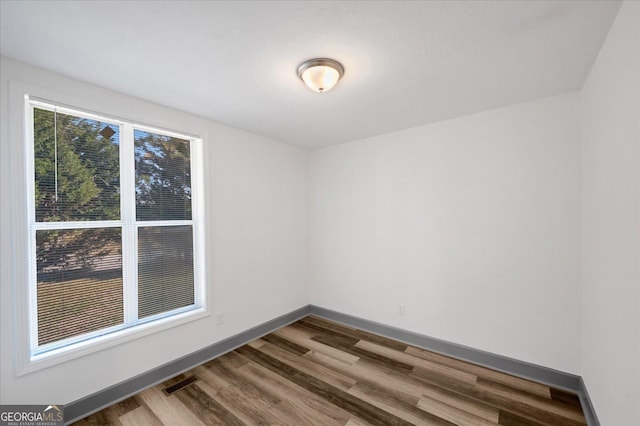 empty room with hardwood / wood-style floors