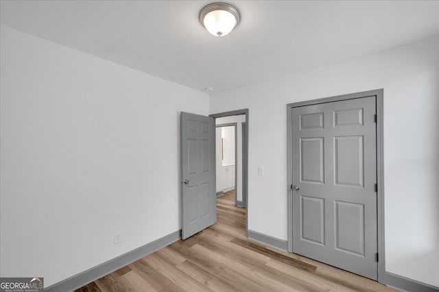 unfurnished bedroom with light wood-type flooring