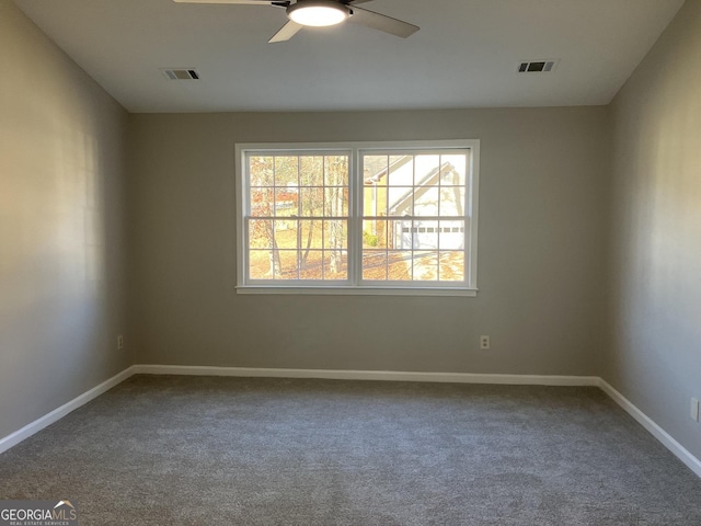 empty room with ceiling fan and carpet floors