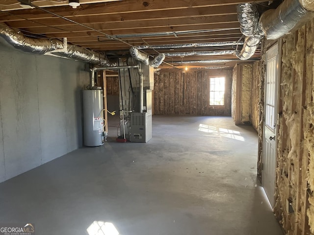 basement featuring heating unit and water heater