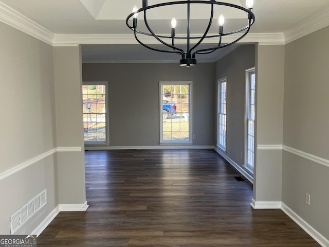 unfurnished dining area with a wealth of natural light, dark hardwood / wood-style flooring, ornamental molding, and an inviting chandelier