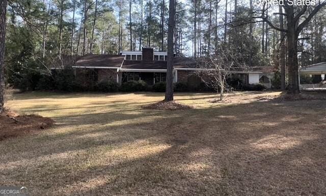 back of house featuring a yard