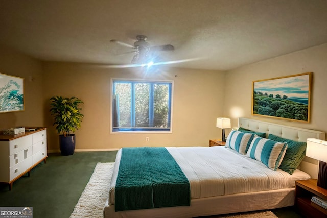 bedroom with dark carpet and a ceiling fan