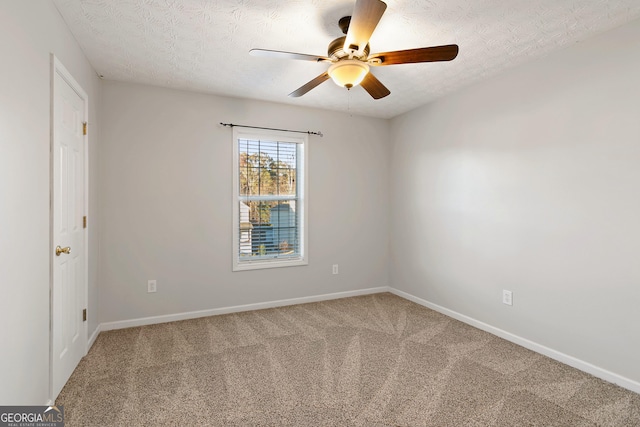 carpeted spare room with ceiling fan and a textured ceiling