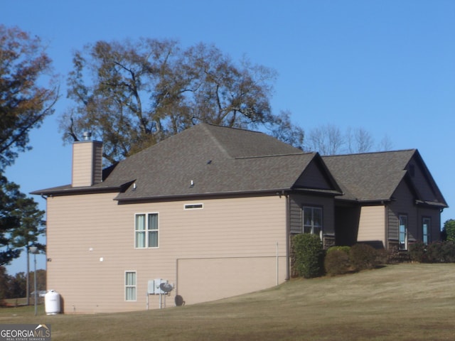 view of home's exterior featuring a yard and a garage