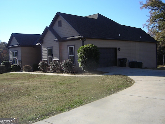 view of property exterior with a lawn, central AC unit, and a garage