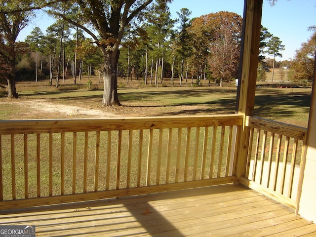 wooden terrace with a lawn