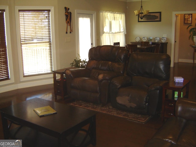 living room featuring plenty of natural light and an inviting chandelier