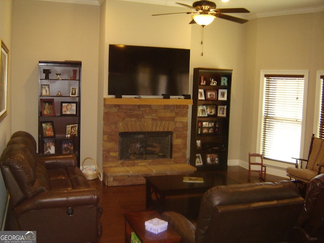 living room with a fireplace, wood-type flooring, ceiling fan, and ornamental molding